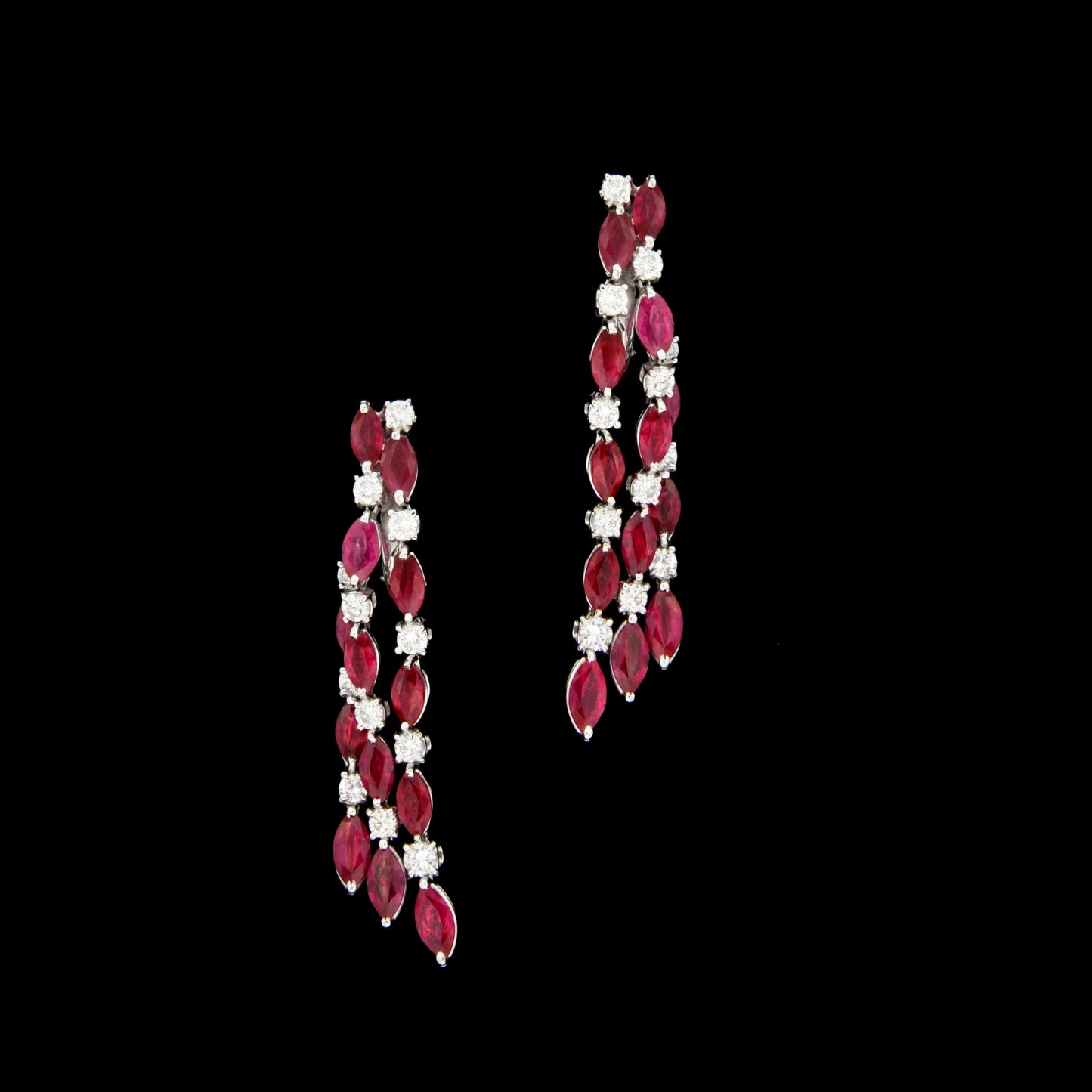 A pair of 18K White Gold tassel earrings featuring 8.65ct Marquise Natural Burma Ruby and 1.72ct Round Natural Diamonds, elegantly cascading for a refined and timeless design.