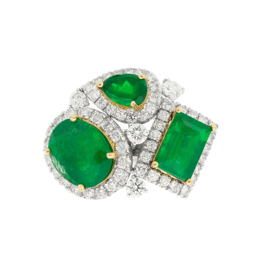 18K White Gold Ring featuring 5.64ct Natural Colombian Emeralds (Oval, Emerald Cut, Pear Shape) surrounded by 1.10ct Round Natural Diamonds in an asymmetrical design.