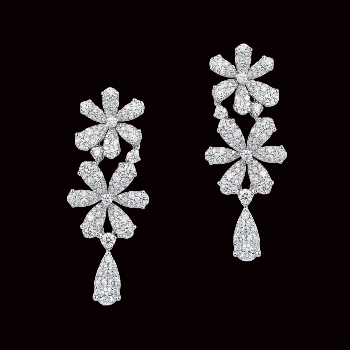 Pair of floral diamond earrings on a white background