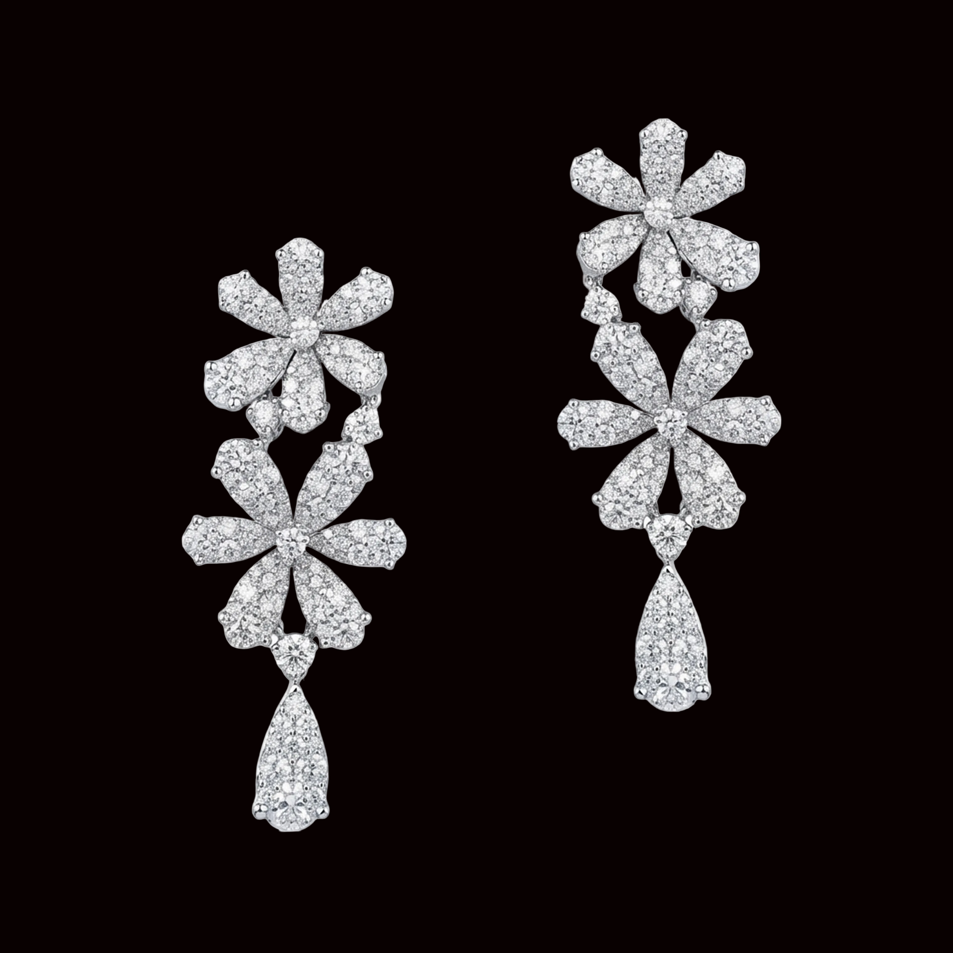 Pair of floral diamond earrings on a white background