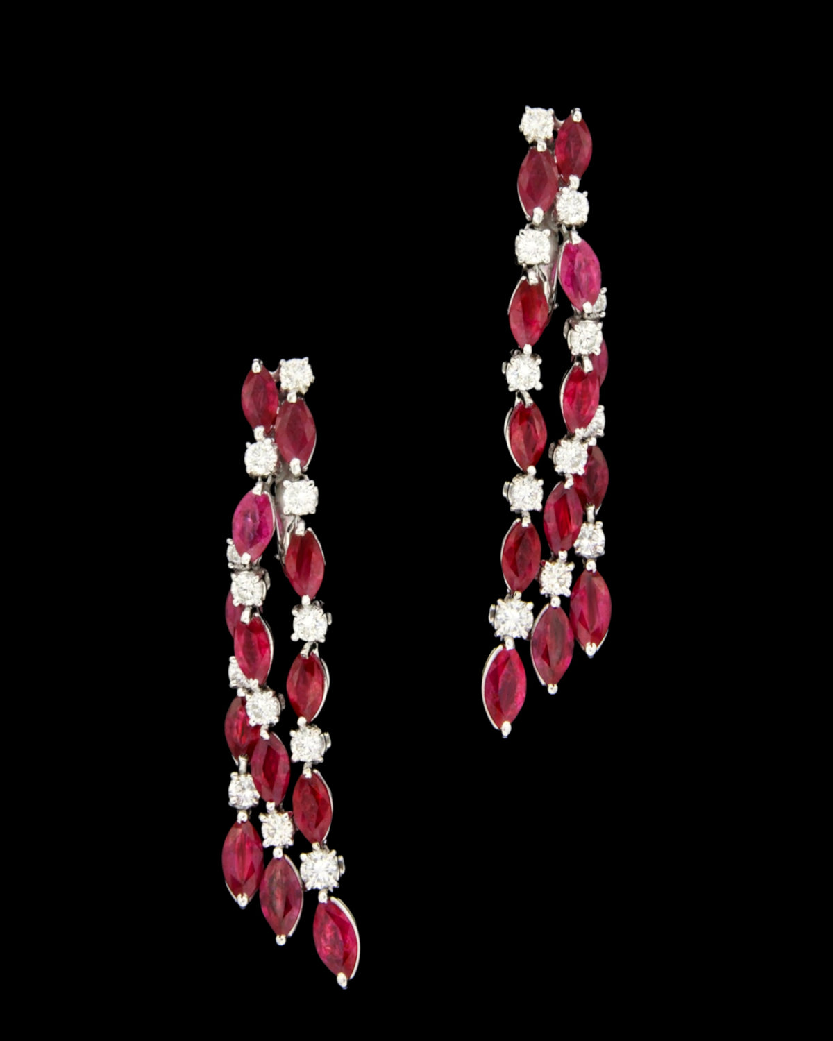 Marquise ruby and diamond tassel earrings in 18K white gold with the cascading strands spread against black, reference 1018E.