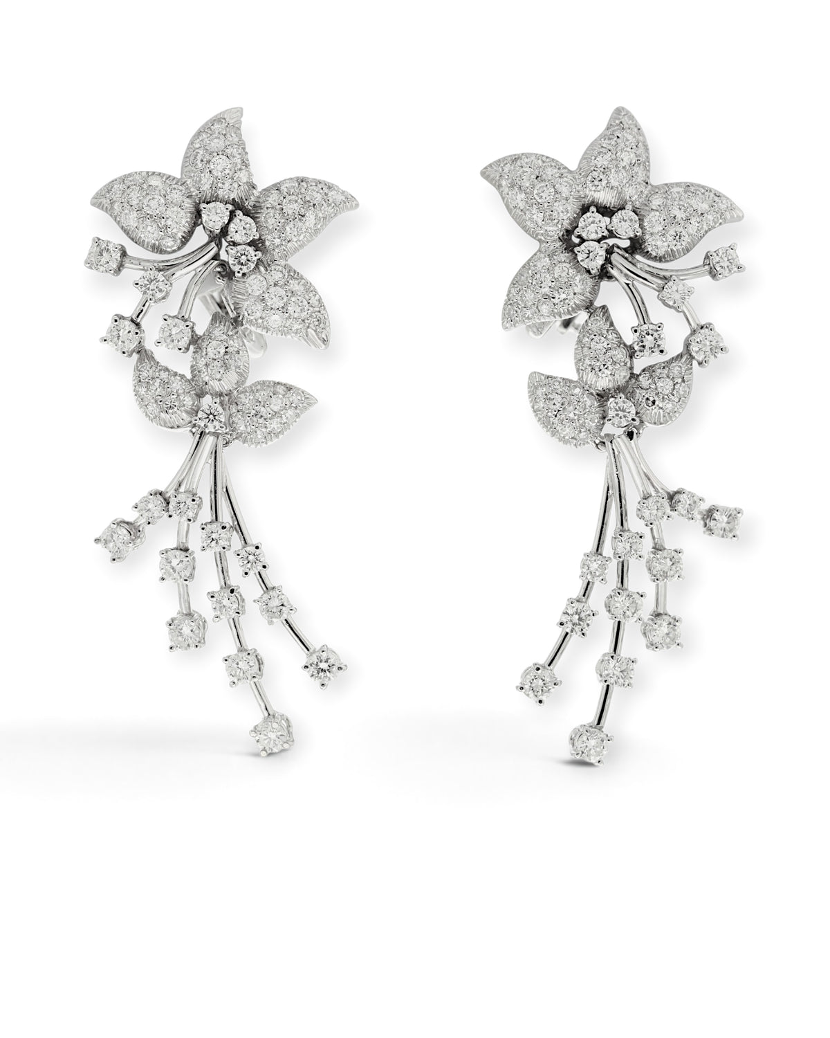 Front view of floral diamond drop earrings in 18K white gold, with two flower motifs and cascading stems on each earring, reference 1030E.