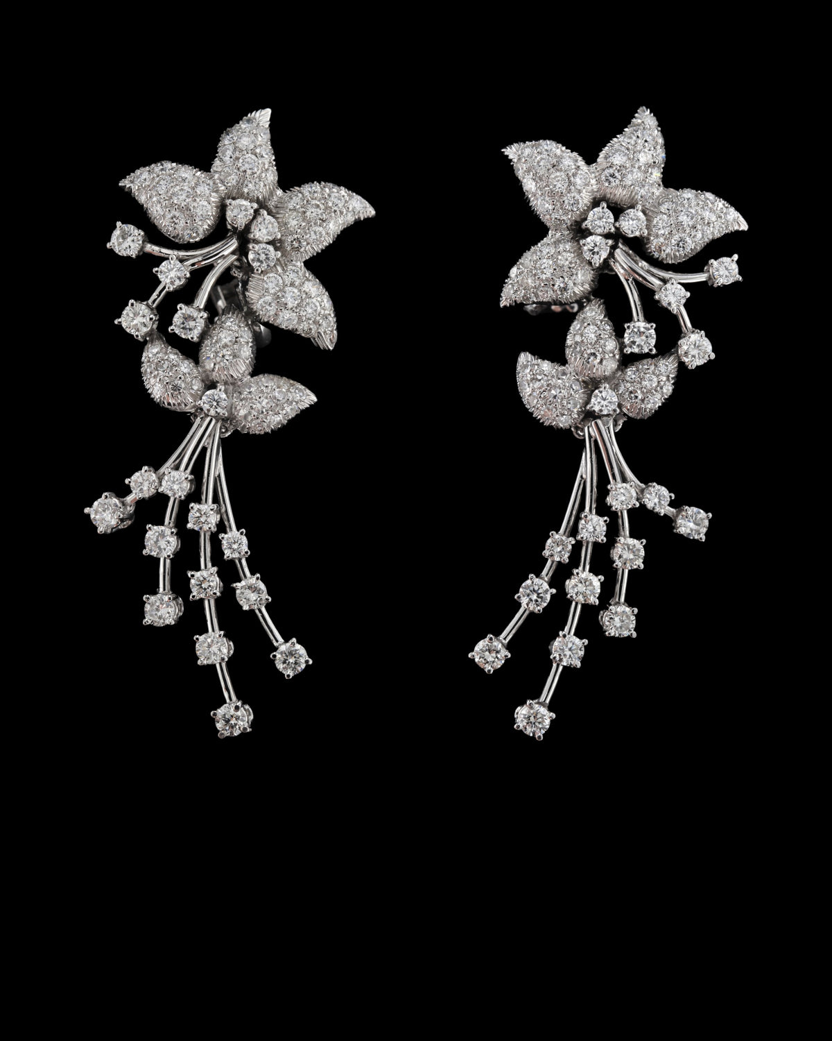 Floral diamond drop earrings in 18K white gold with cascading diamond-set stems, reference 1030E.