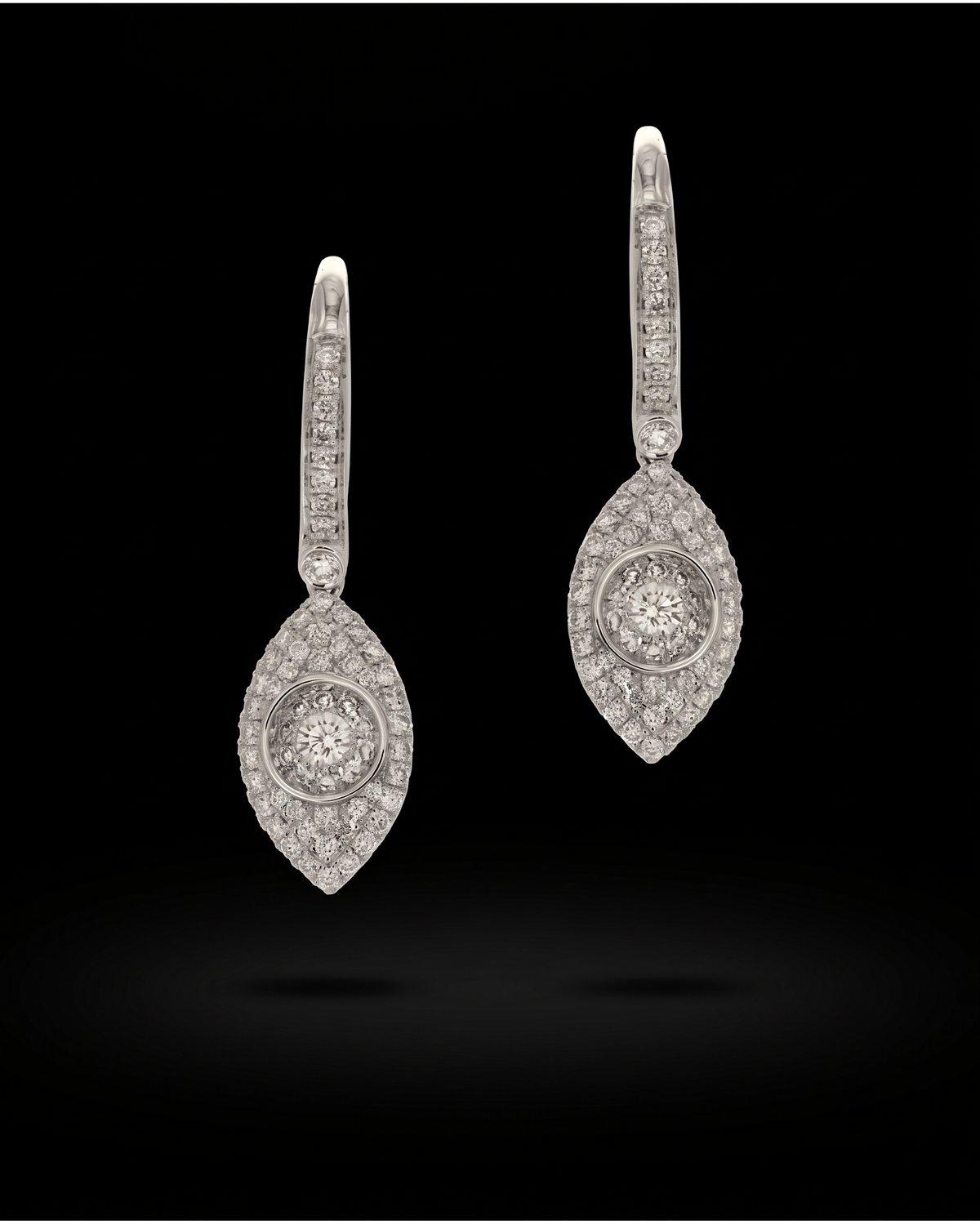 18K white gold diamond drop earrings with navette-shaped surrounds and diamond-set hooks, reference 1953E.
