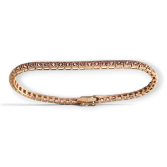Pink sapphire tennis bracelet in 18K rose gold, shown in an oval arrangement with its clasp, reference 2515B.