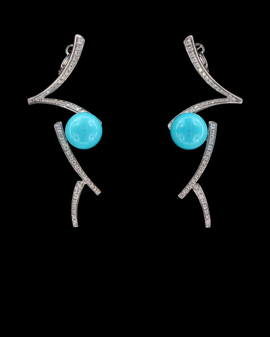 Caeruleum 18K white gold earrings with bright blue spherical accents and curved diamond-set lines, reference 834E.