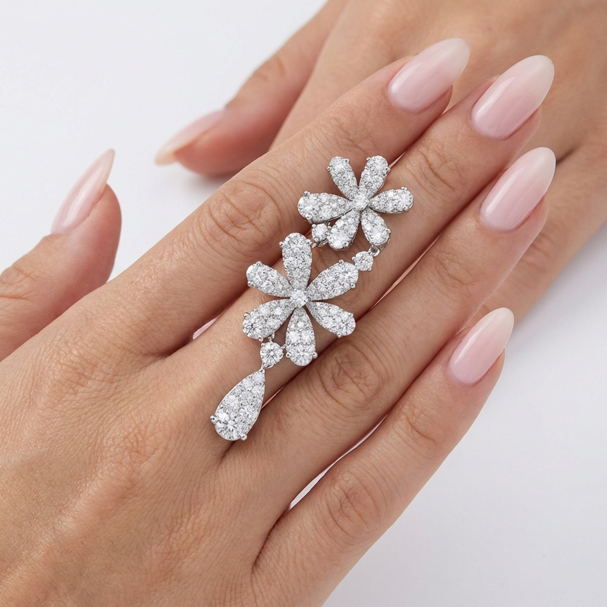hofjewellery Flora 18k white gold floral earrings featuring 7.32-carat brilliant diamonds on a model's hand