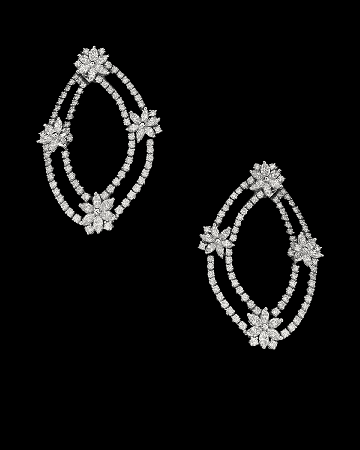 hofjewellery Jasmin Cascade 18K white gold earrings featuring marquise and brilliant round diamonds in a floral design.