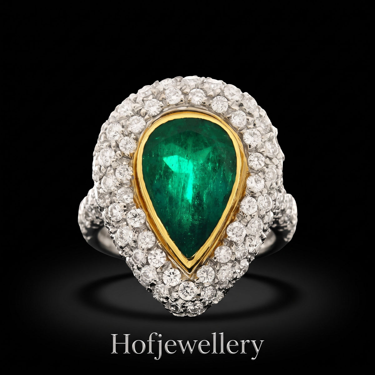 hofjewellery pear-shaped Colombian emerald ring with a diamond halo set in 18K white gold on a black background