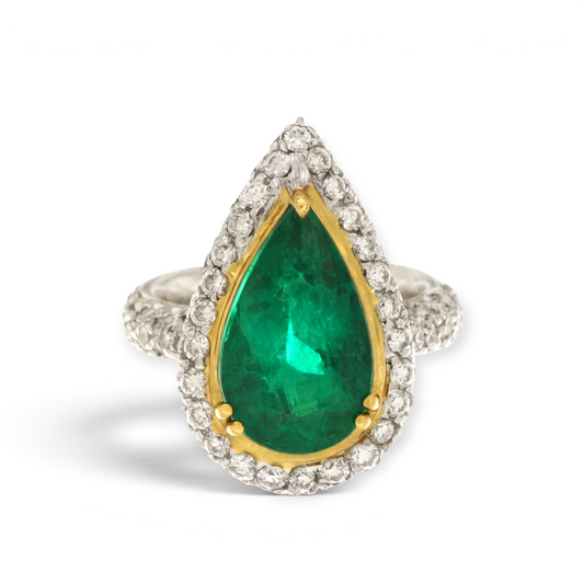 hofjewellery pear-shaped Colombian emerald ring with a diamond halo set in 18K white gold and yellow gold bezel