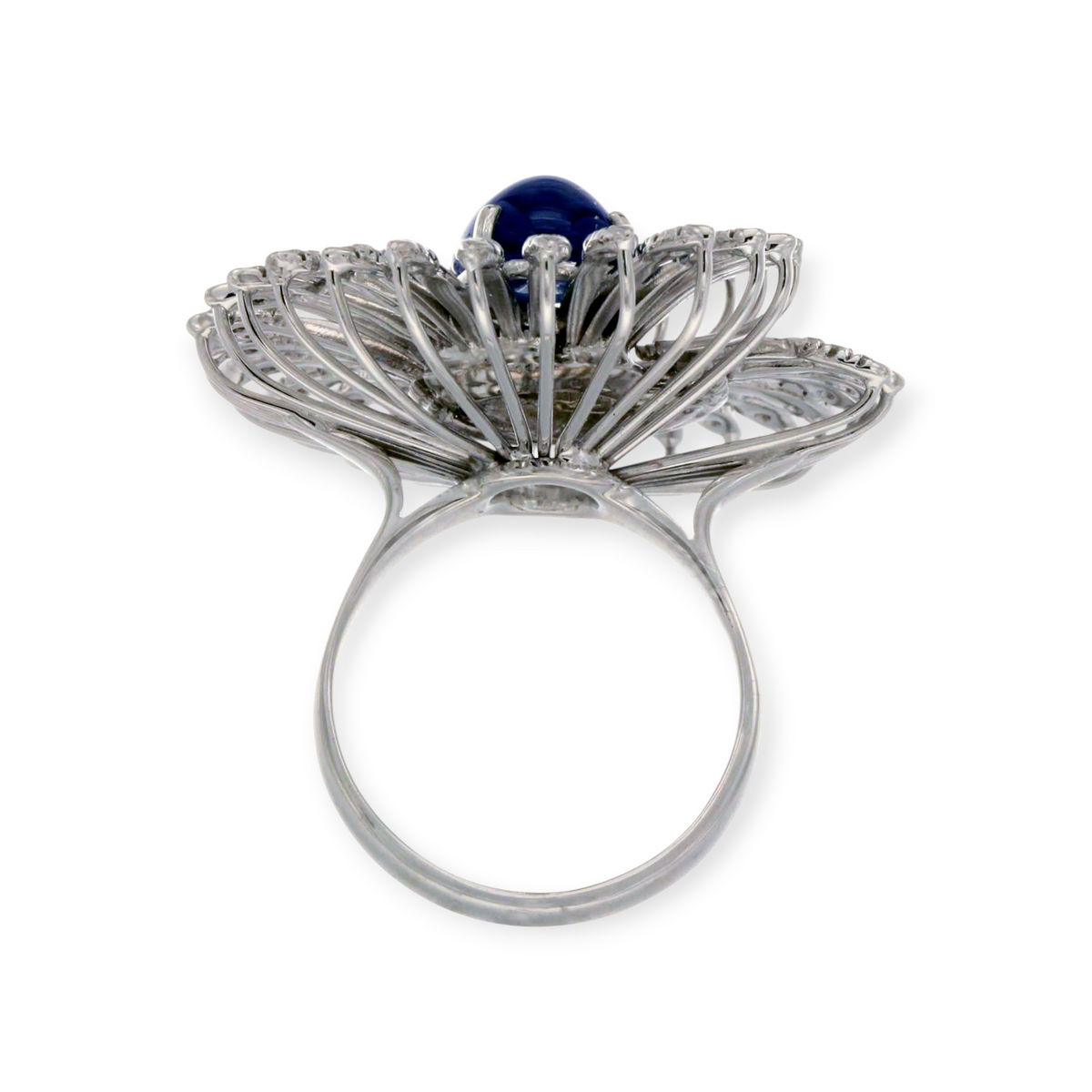 hofjewellery 18K white gold cocktail ring with a central cabochon sapphire and swirling diamond-adorned petals.